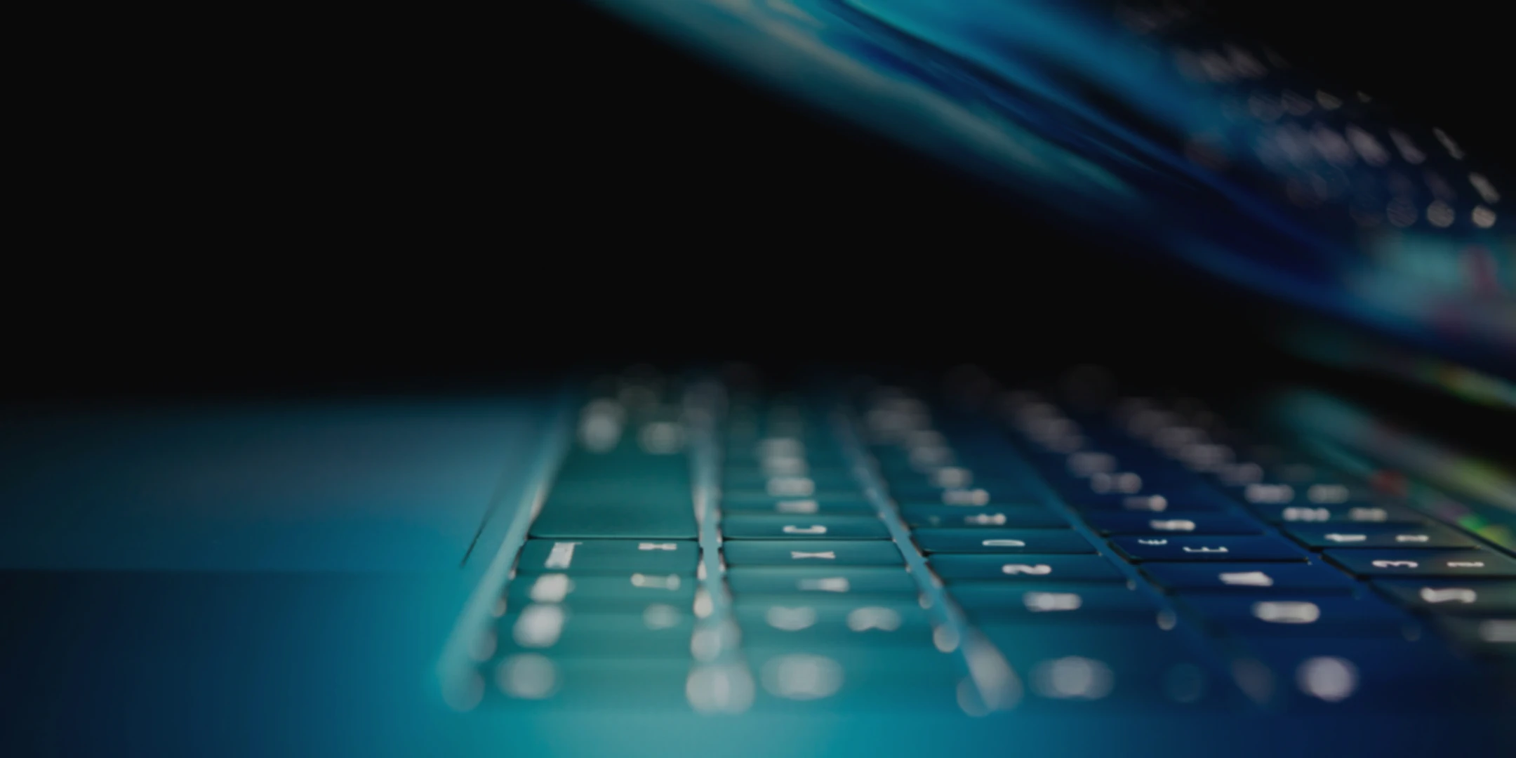 Close-up of a half-closed laptop.