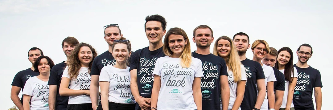 Group of Helpware employees wearing branded t-shirts with the slogan 'We've got your back'