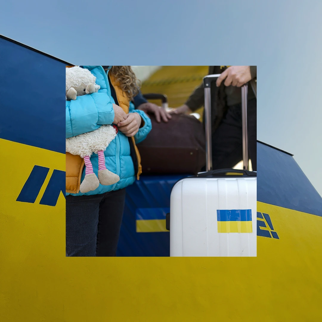 Family at an airport with luggage showing the Ukrainian flag