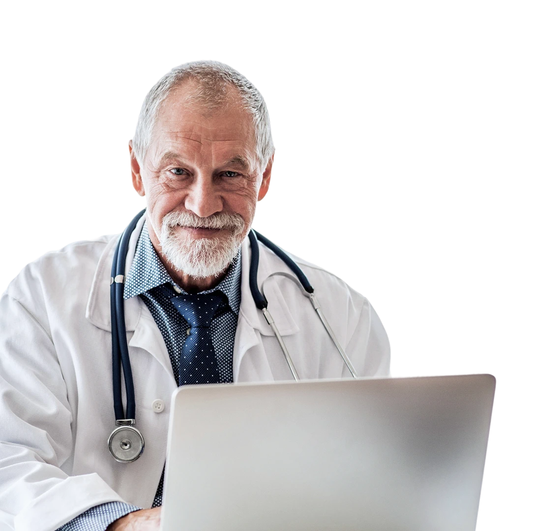 Smiling senior male doctor wearing white coat and stethoscope working on a laptop