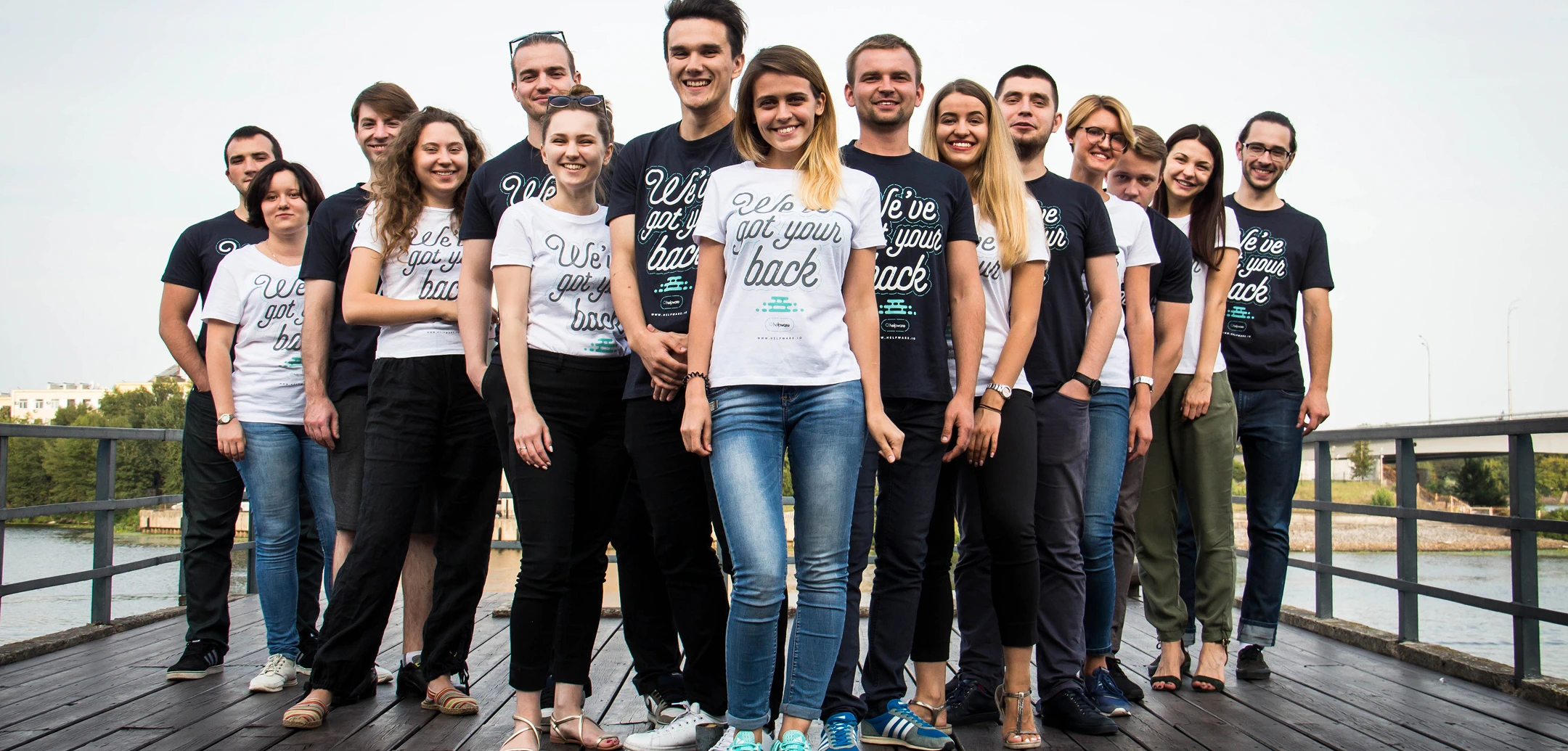 Group of Helpware employees wearing branded t-shirts with the slogan 'We've got your back'