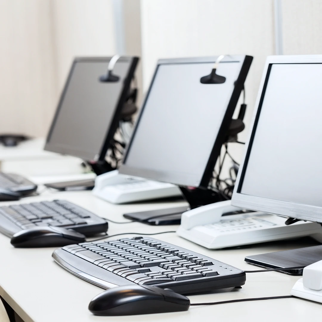 Call center setup with computers, headsets, and phones