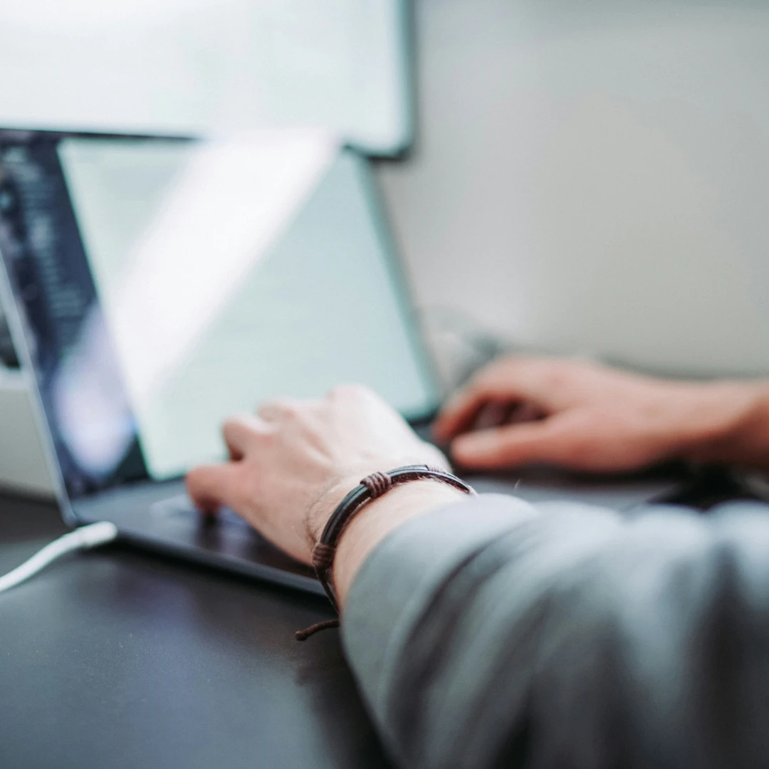 Close-up of hands using a laptop
