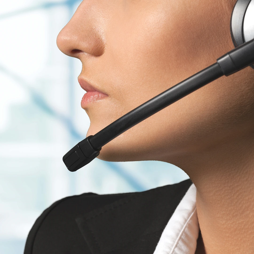 Close-up of a woman's face wearing a headset microphone