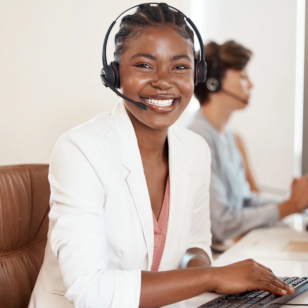 Cheerful customer service agent in a white blazer and headset, ready to help