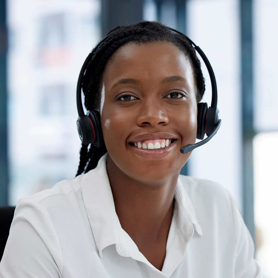 Friendly customer service representative in a white blouse with a headset in a Chicago call center