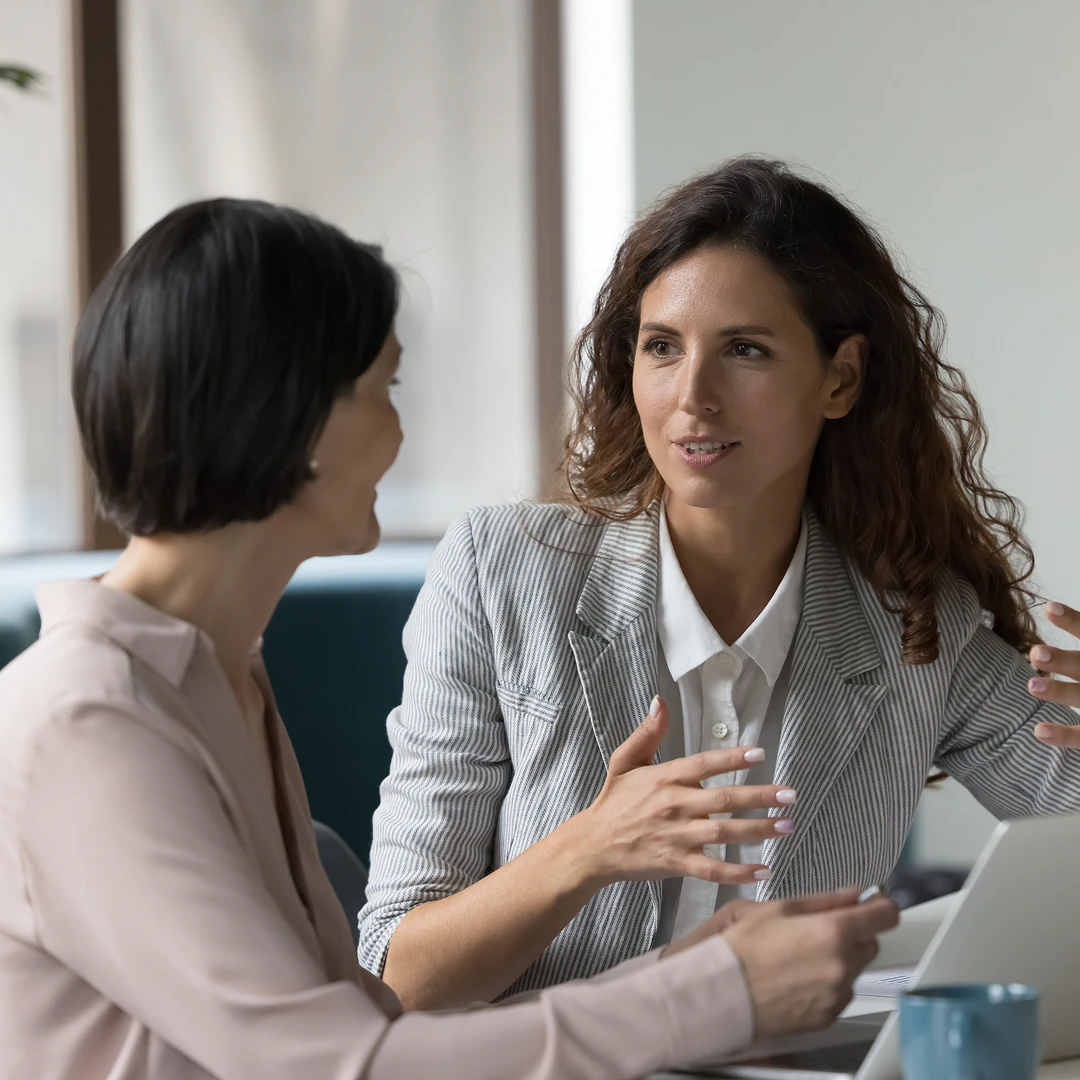 Two businesswomen talking and gesturing