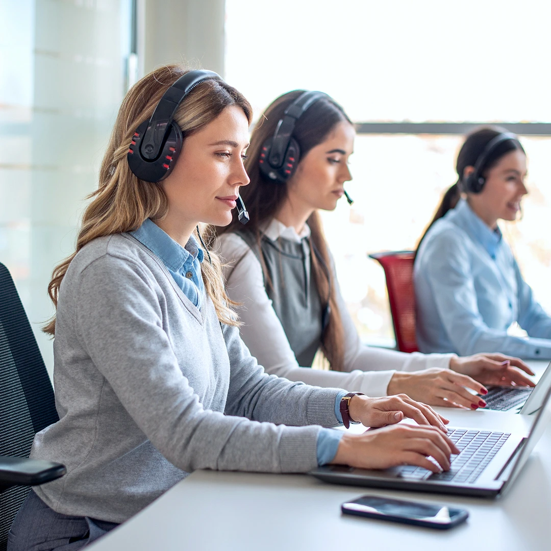 Professional female customer support representatives answering calls in a call center in San Francisco