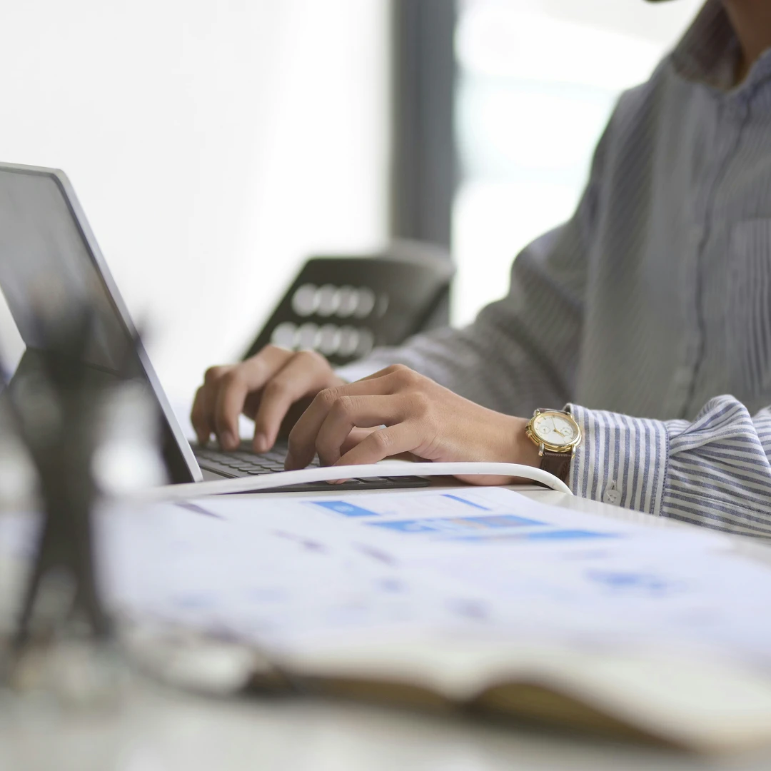 Financial contact center representative working at her desk on a computer
