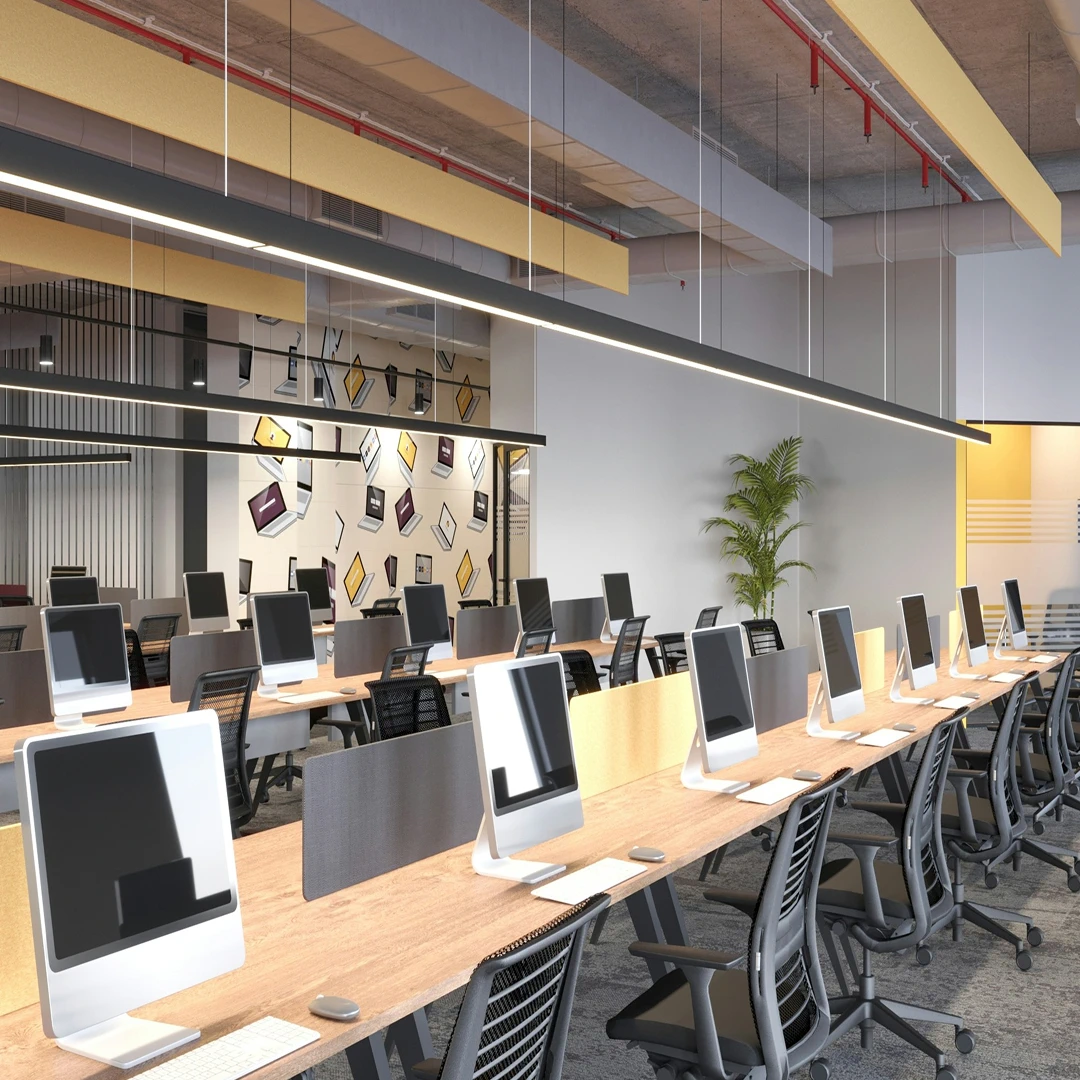 A brightly lit, modern office space with rows of desks and computers