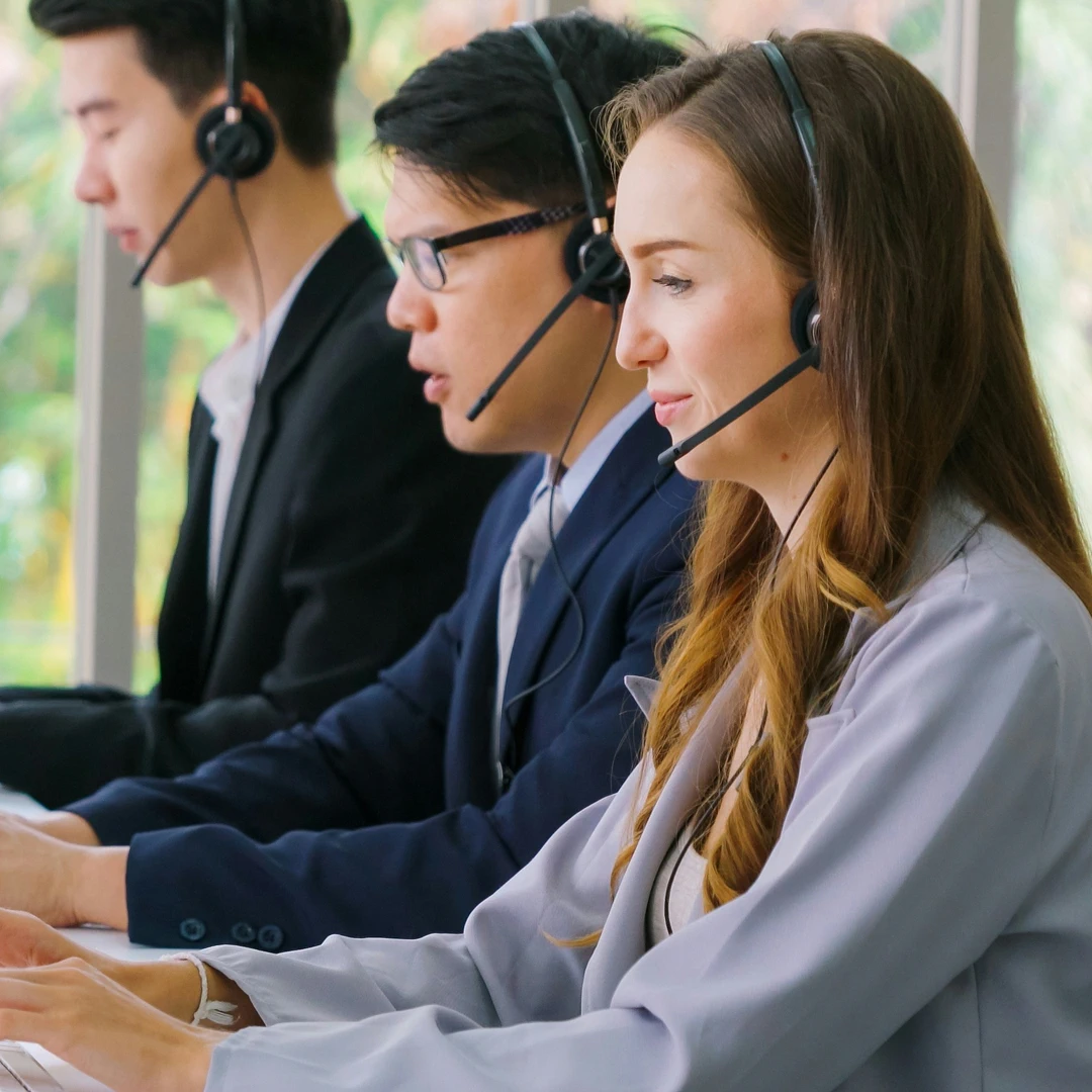 Ecommerce customer support representatives wearing headsets, working in a call center