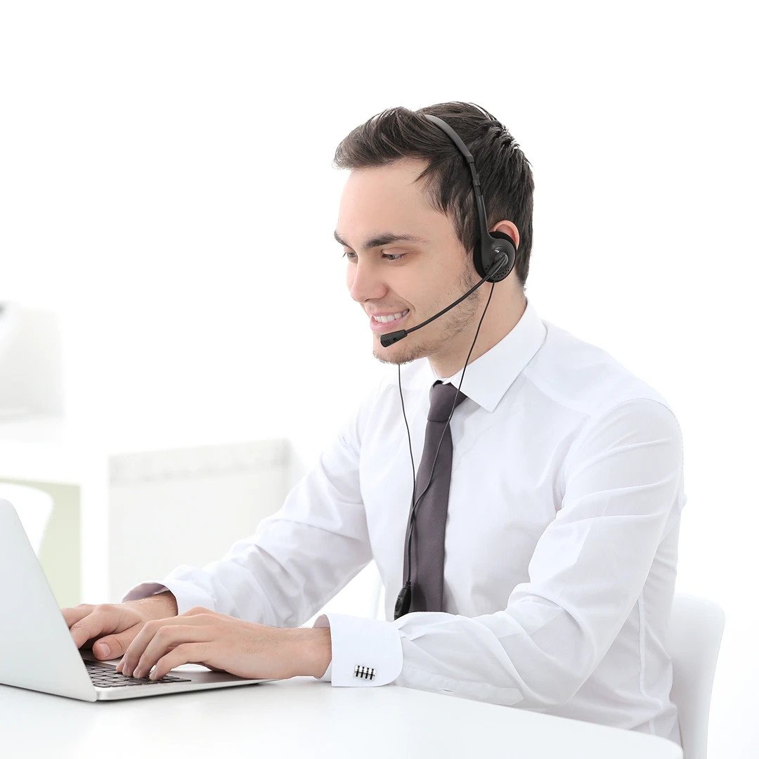 Male customer support representative wearing a white shirt and a headset, providing online support
