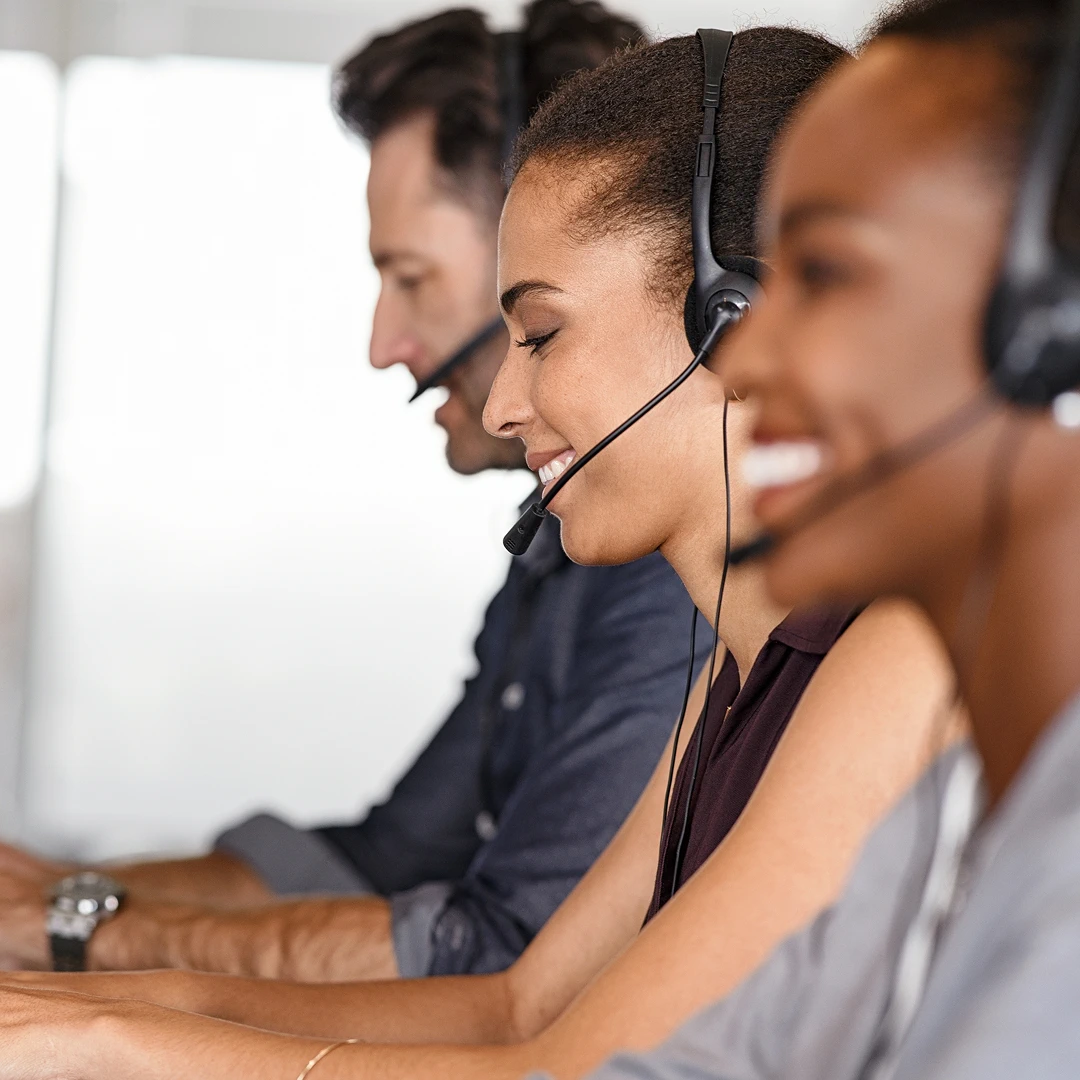 Team of customer support agents diligently working at their workstations