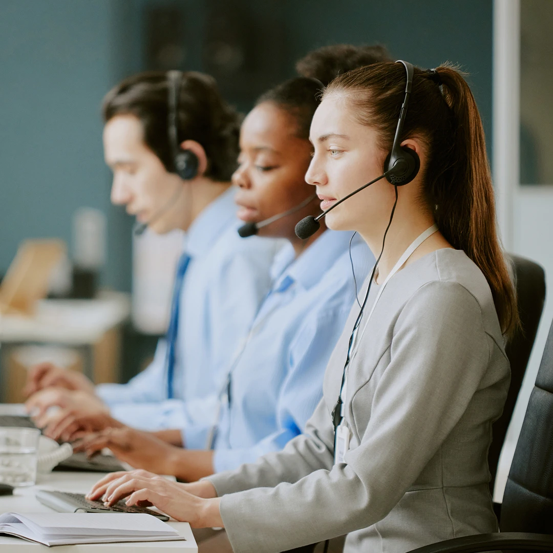 Call center agents working with headsets, providing customer support