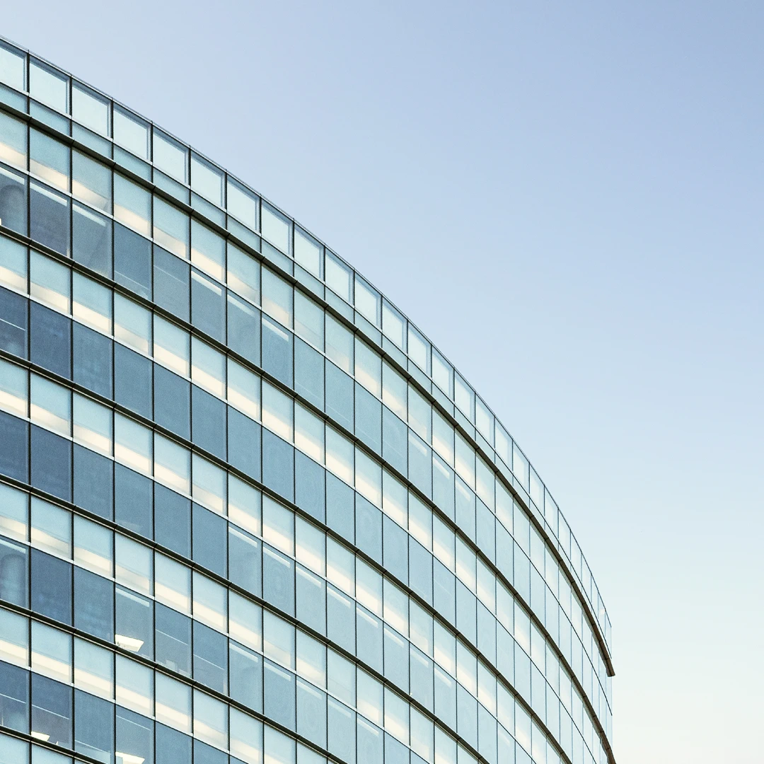 Exterior of a curved office building with many windows