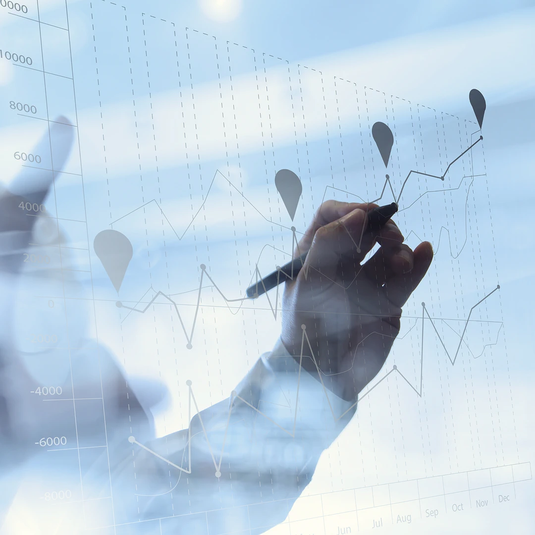 A man is drawing a line graph on the glass