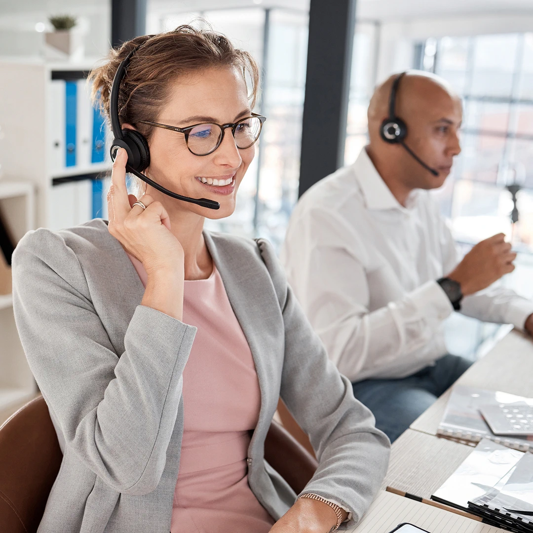 Team of professional customer support specialists wearing headsets, providing excellent service