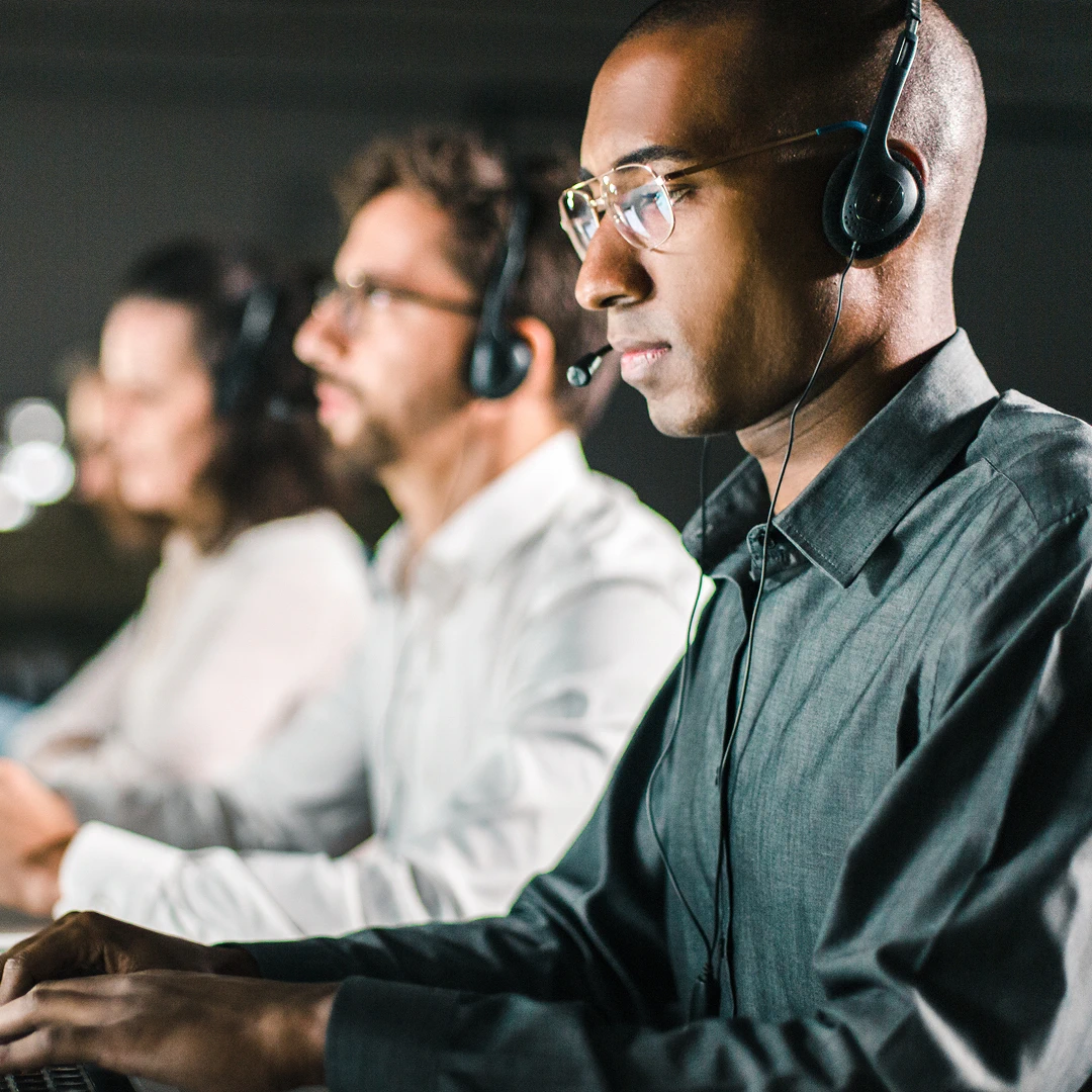 Group of customer support agents working on computers in a Fresno call center