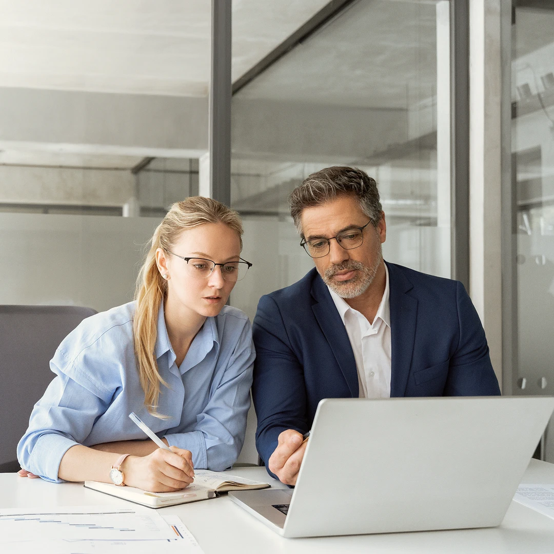Business meeting with a man and a woman wearing suits, communicating with each other in a modern call center office in Miami