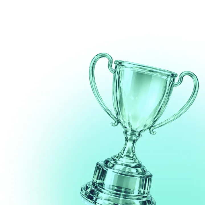 Transparent trophy on a turquoise and white background.