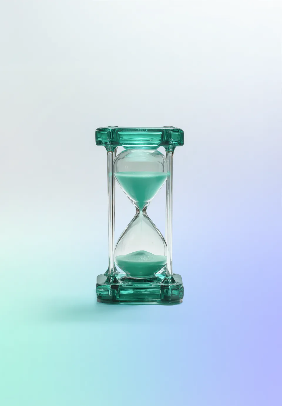 Transparent hourglass on a gradient background.
