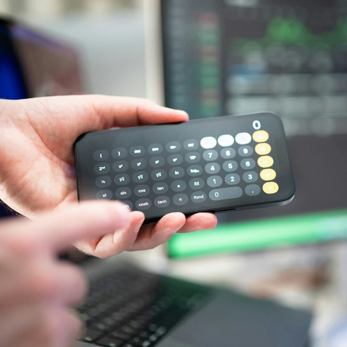 someone holding their iphone with the calculator app open showing 0