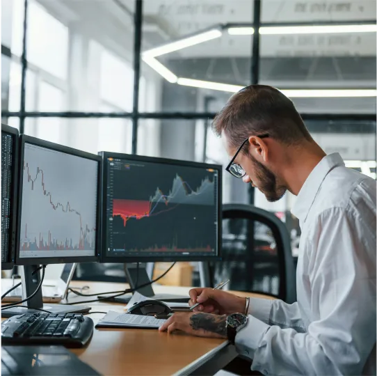 a man wearing glasses working on something