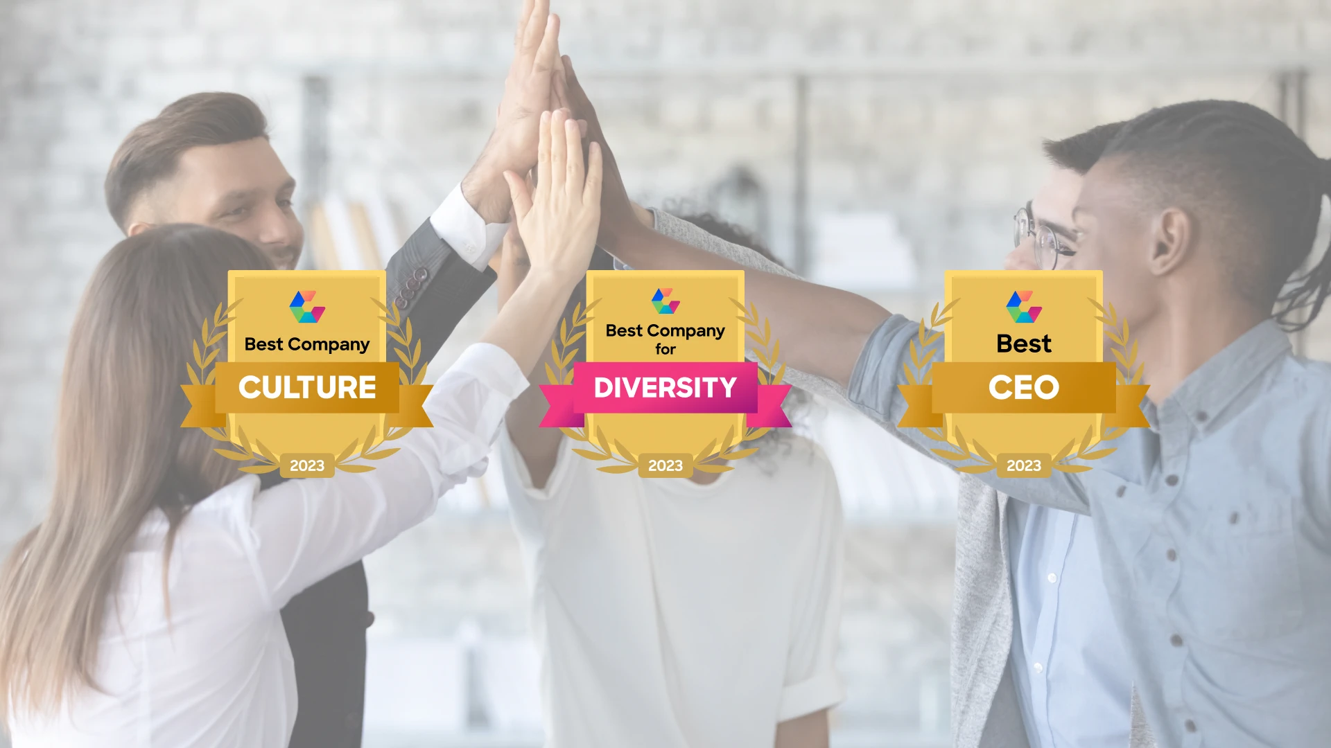 A group of five professionals is giving a high five in a modern office setting