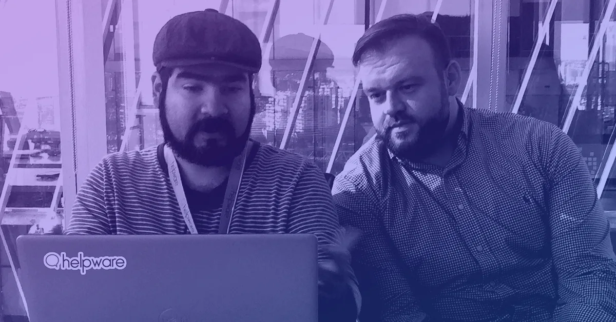 Two men are reviewing information on a laptop, and one of them is Robert Nash, the CEO of Helpware