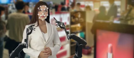 A woman in a white suit has her face scanned with a face detection overlay
