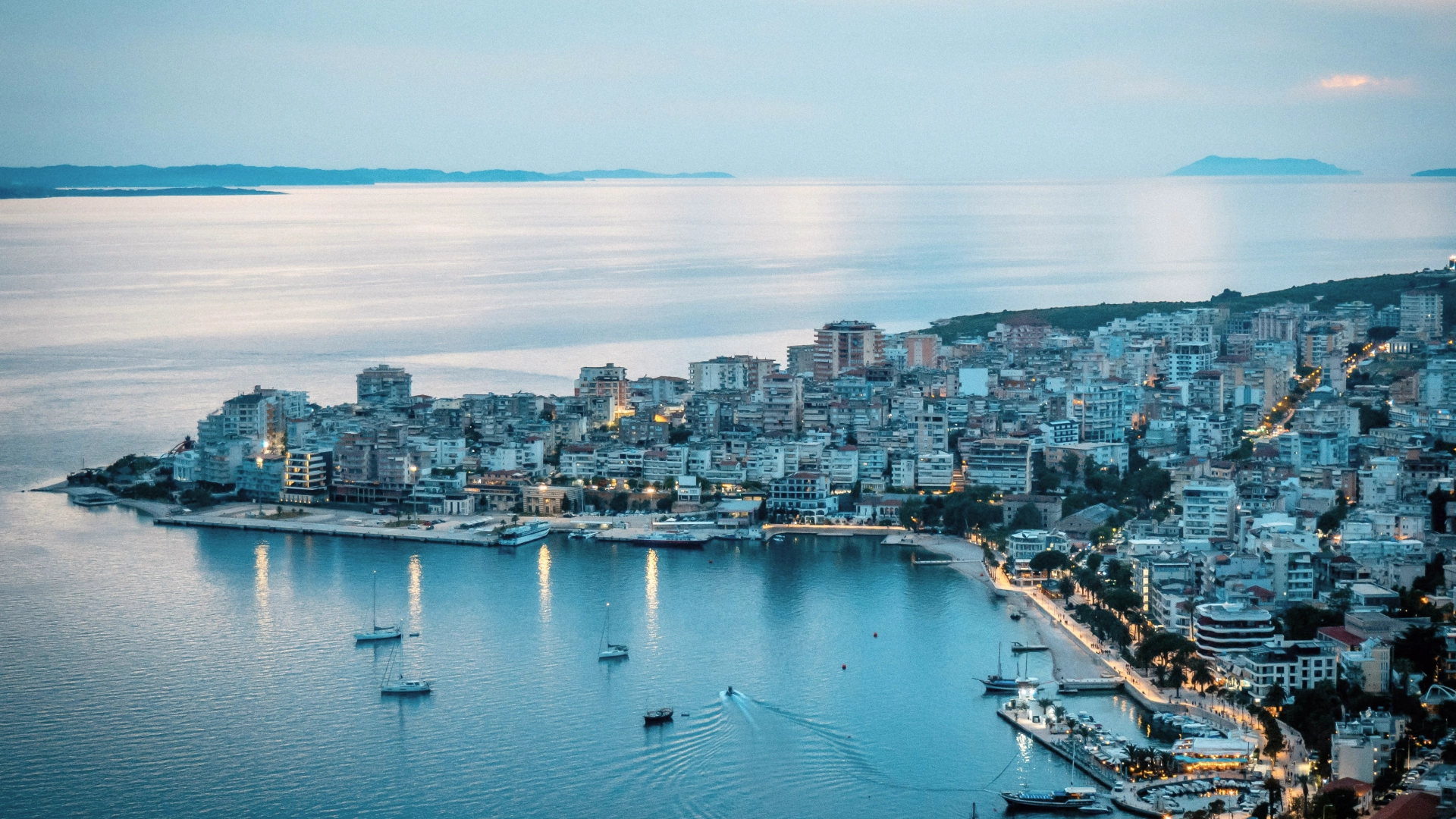 Coastal city in Albania with white buildings overlooking the sea.