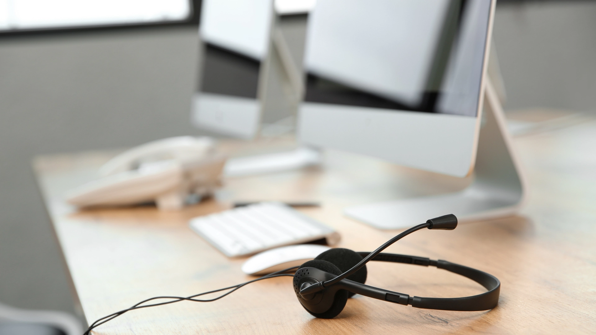 Headset on a desk, ready for customer support activities in a call center environment.