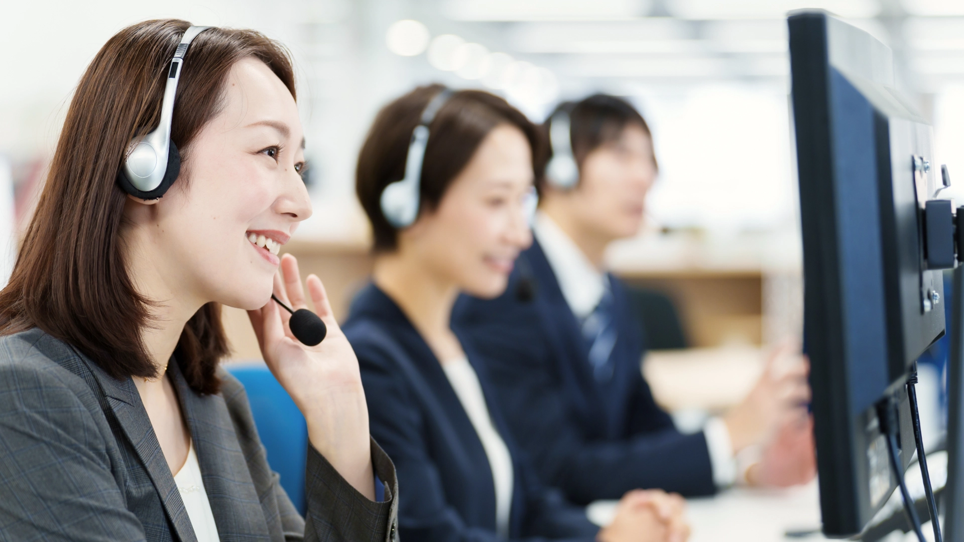 Smiling team of customer support agents providing excellent service.