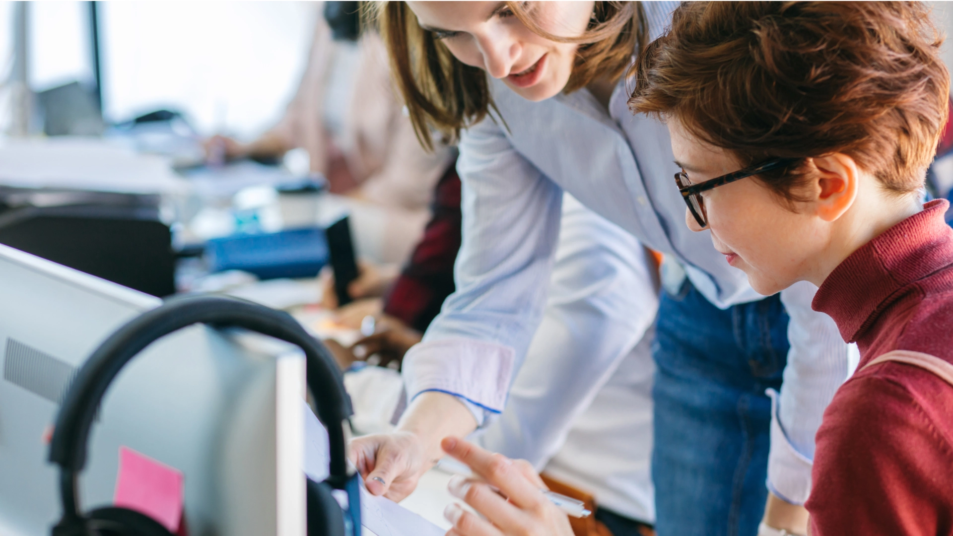 Team members collaborate and provide support to each other in the office.