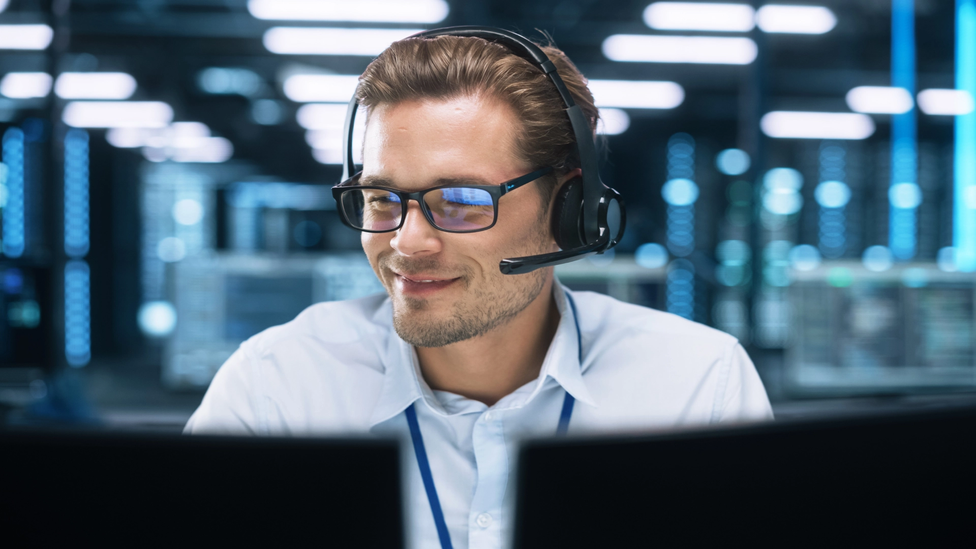 Professional wearing glasses and a headset, providing technical expertise or support.