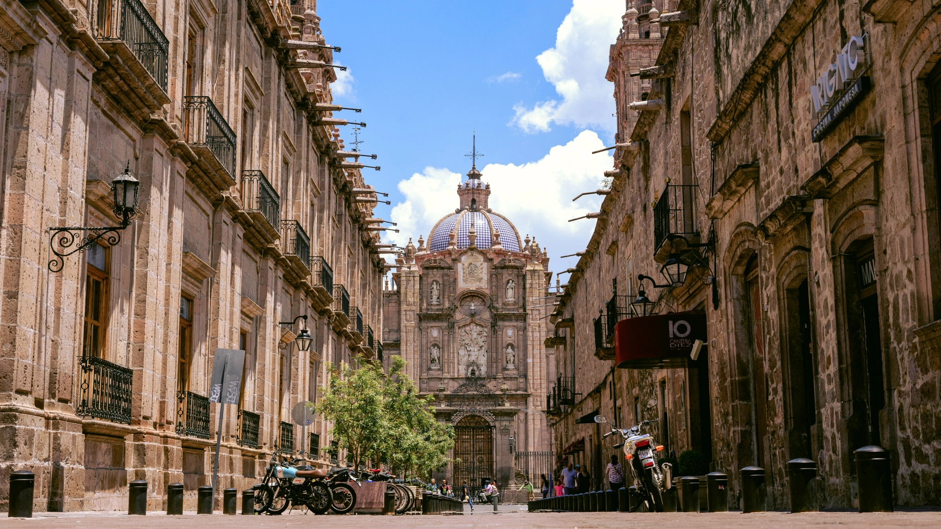 Street in Morelia, Mexico, leading to the historic cathedral with its distinctive blue-tiled dome.
