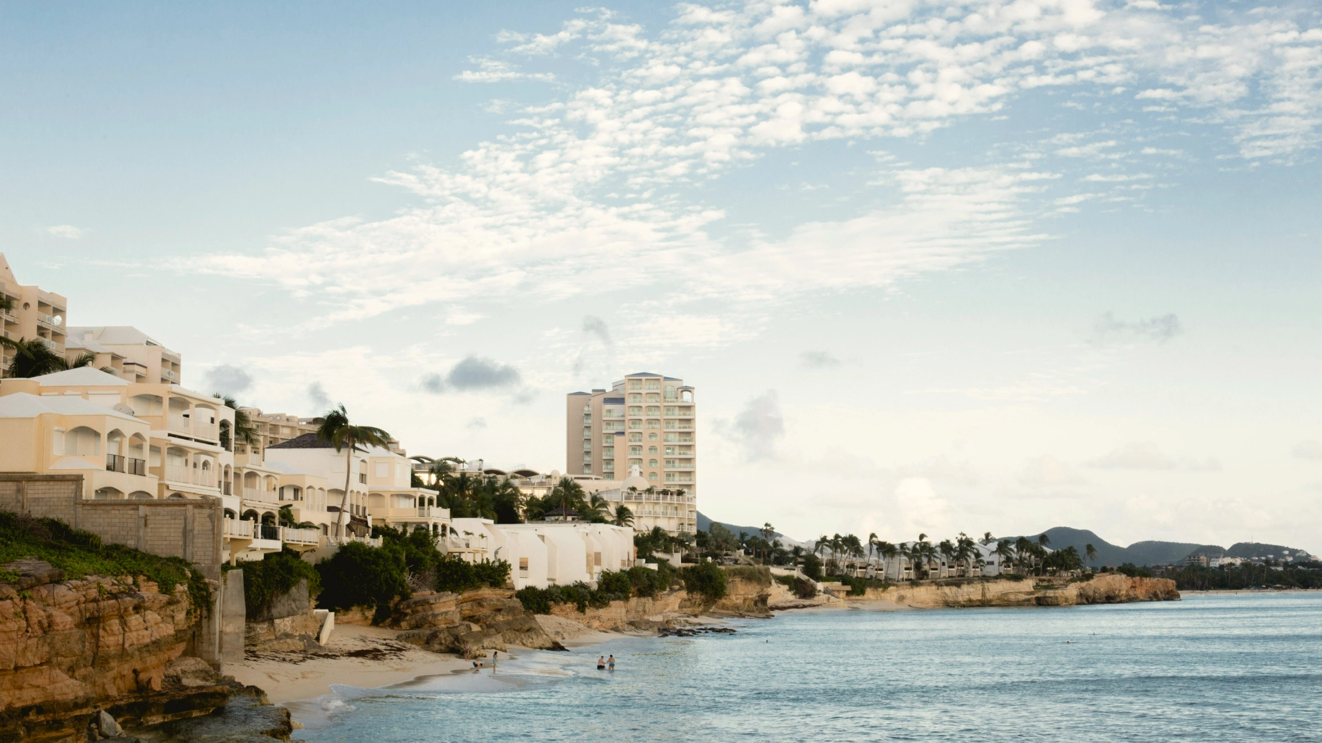 Beautiful coastal scenery in Puerto Rico with white buildings and a sandy beach. 