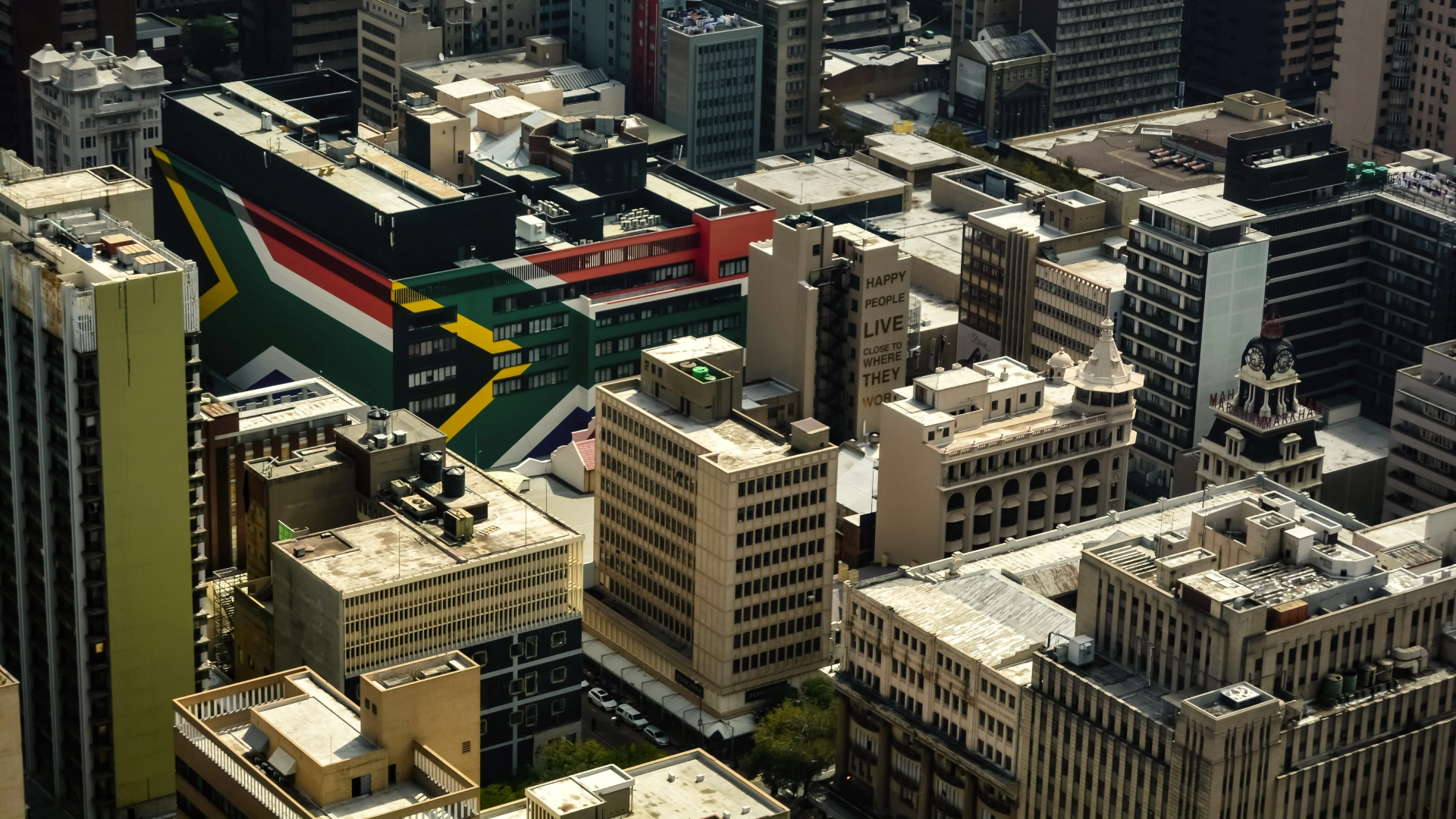 Johannesburg cityscape featuring a building painted with the South African flag. 