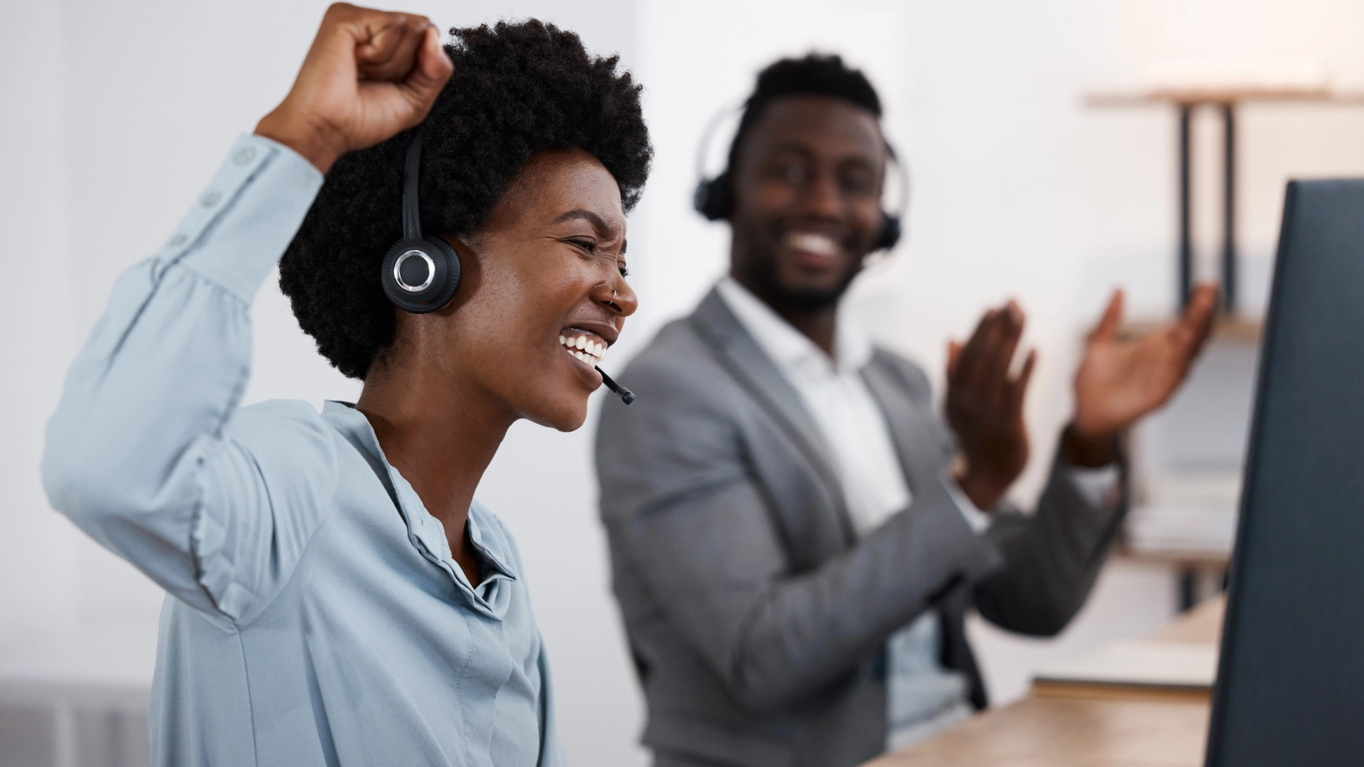 Customer support team celebrating a successful outcome.