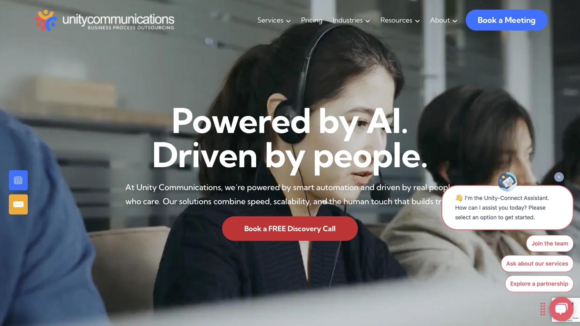 The Unity Communications website homepage showcases the tagline 'Powered by AI. Driven by people'. In the background, a woman and her colleagues are working while wearing headsets.